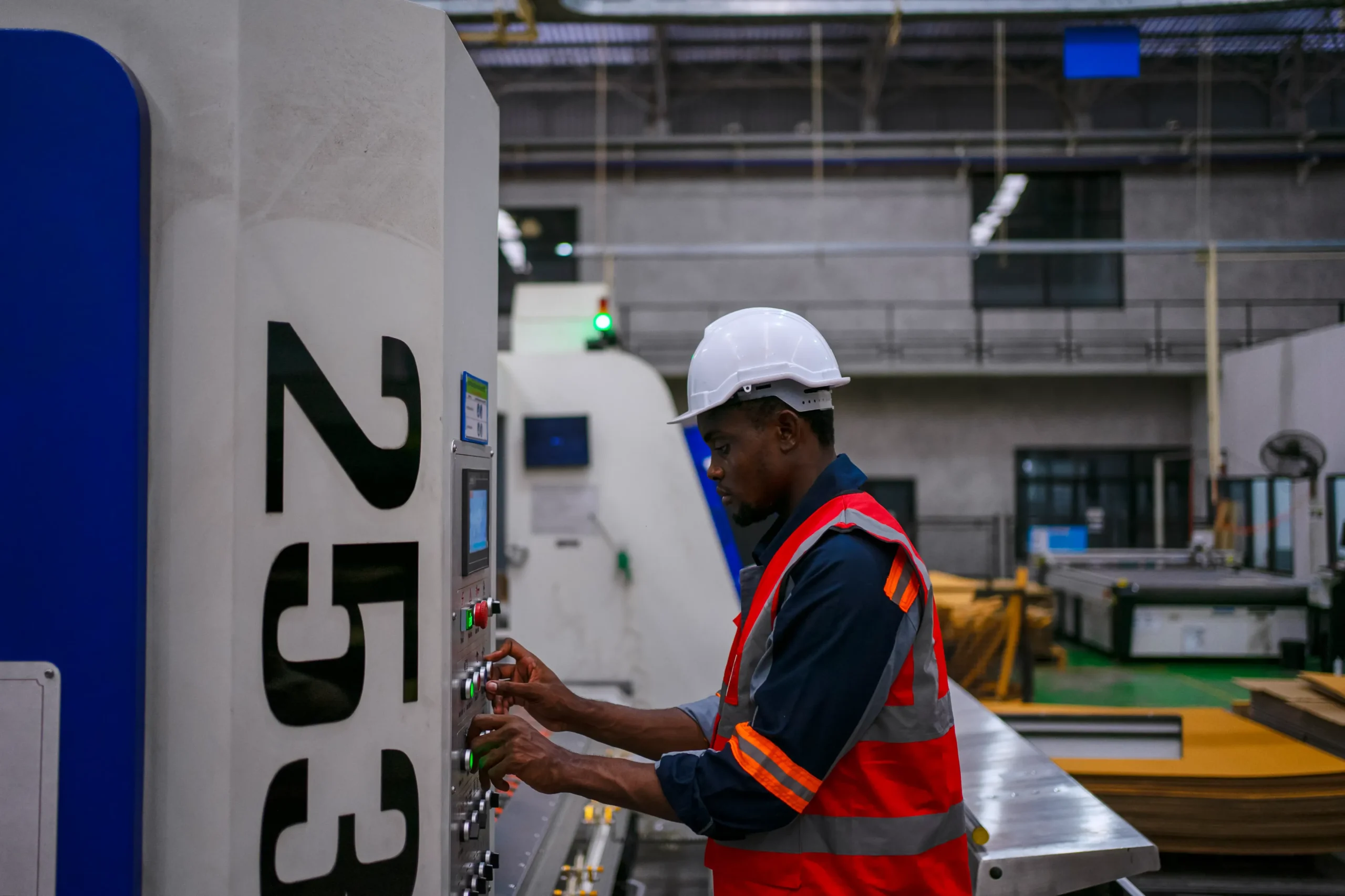 male-factory-worker-operating-machine-control-pane-2026-06-11-19-24-10-utc